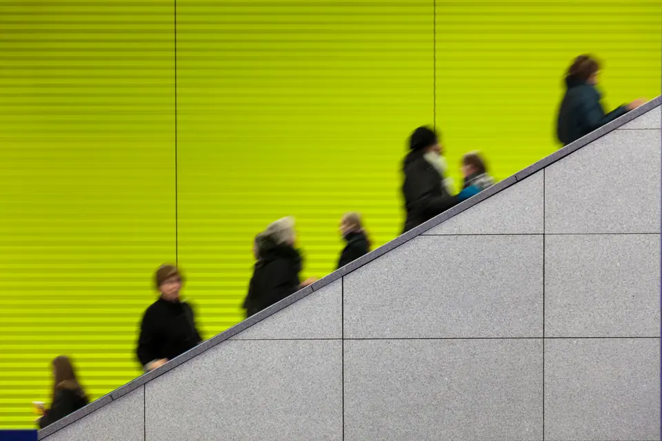 Motion blurred commuters at modern underground platform - grey marble in front - copy space - camera canon 5D mark II - unsharped RAW - adobe colorspace
