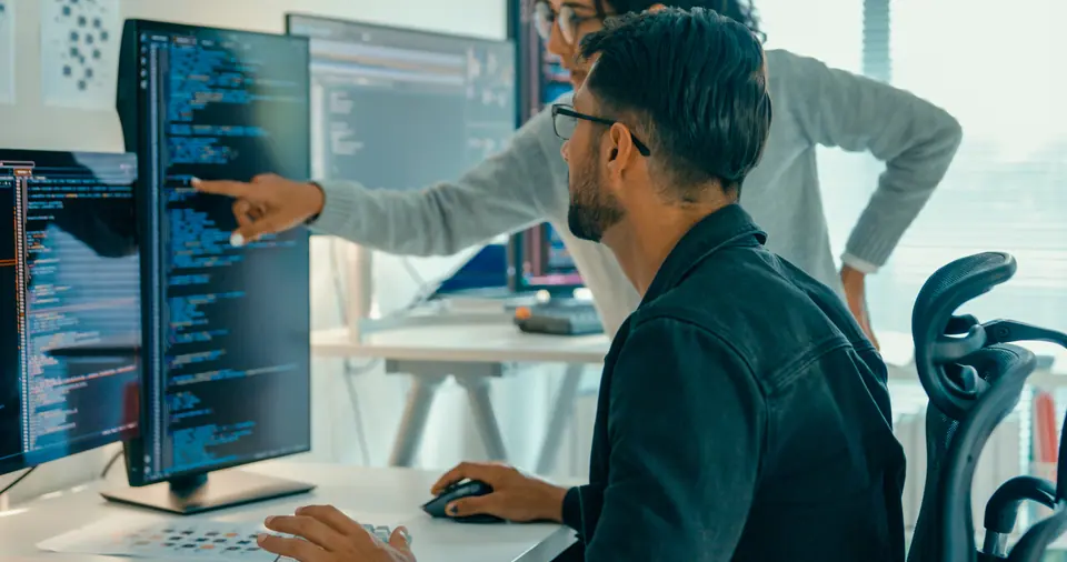 Tech team professionals collaborate discuss software development strategies in modern office
