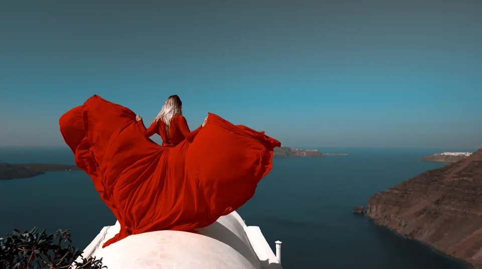 Creative red fabric installation overlooking a coastline, representing ideas and published insights